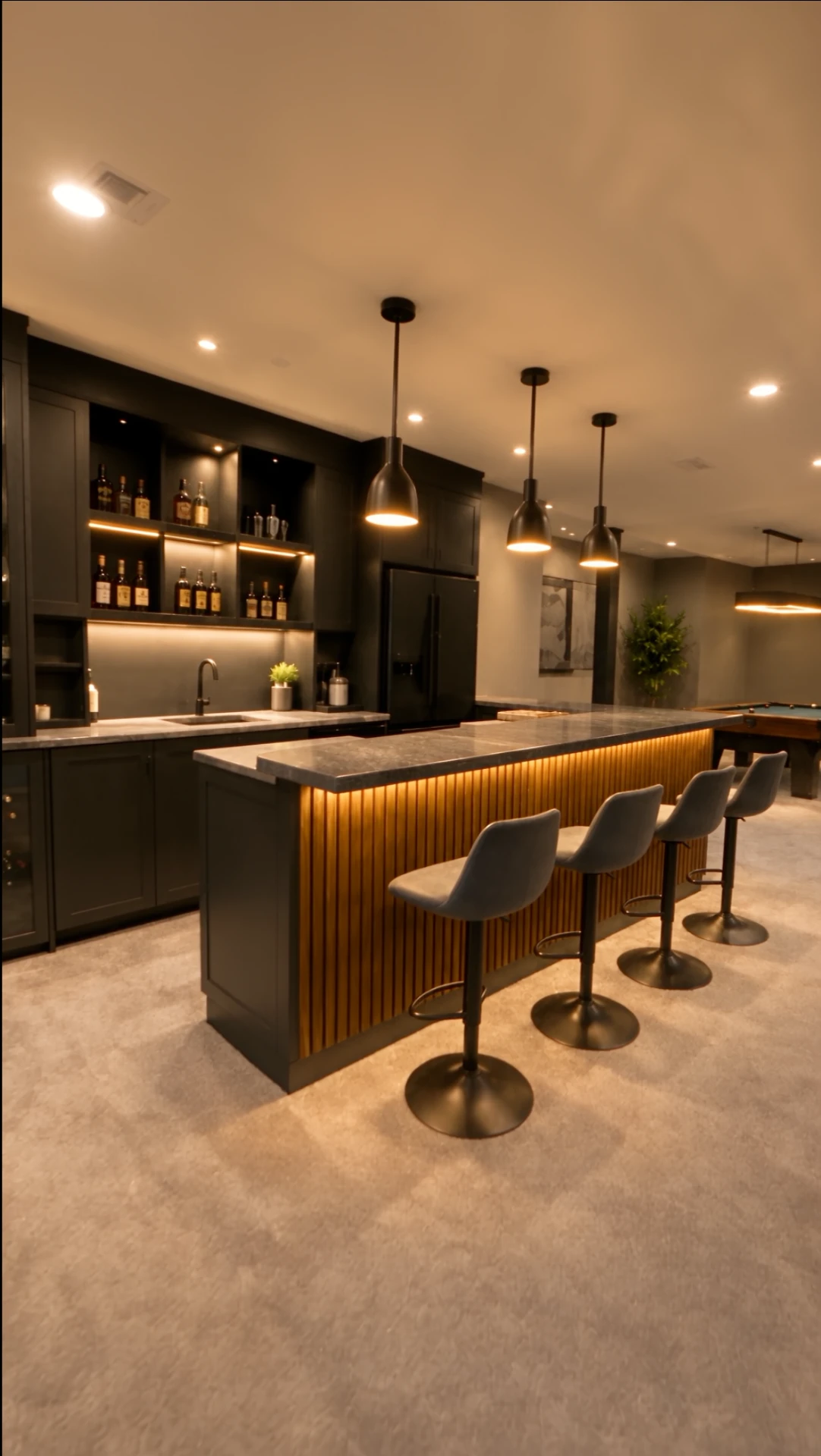 Bar counter with backlit liquor shelves, sink, and pendant lights